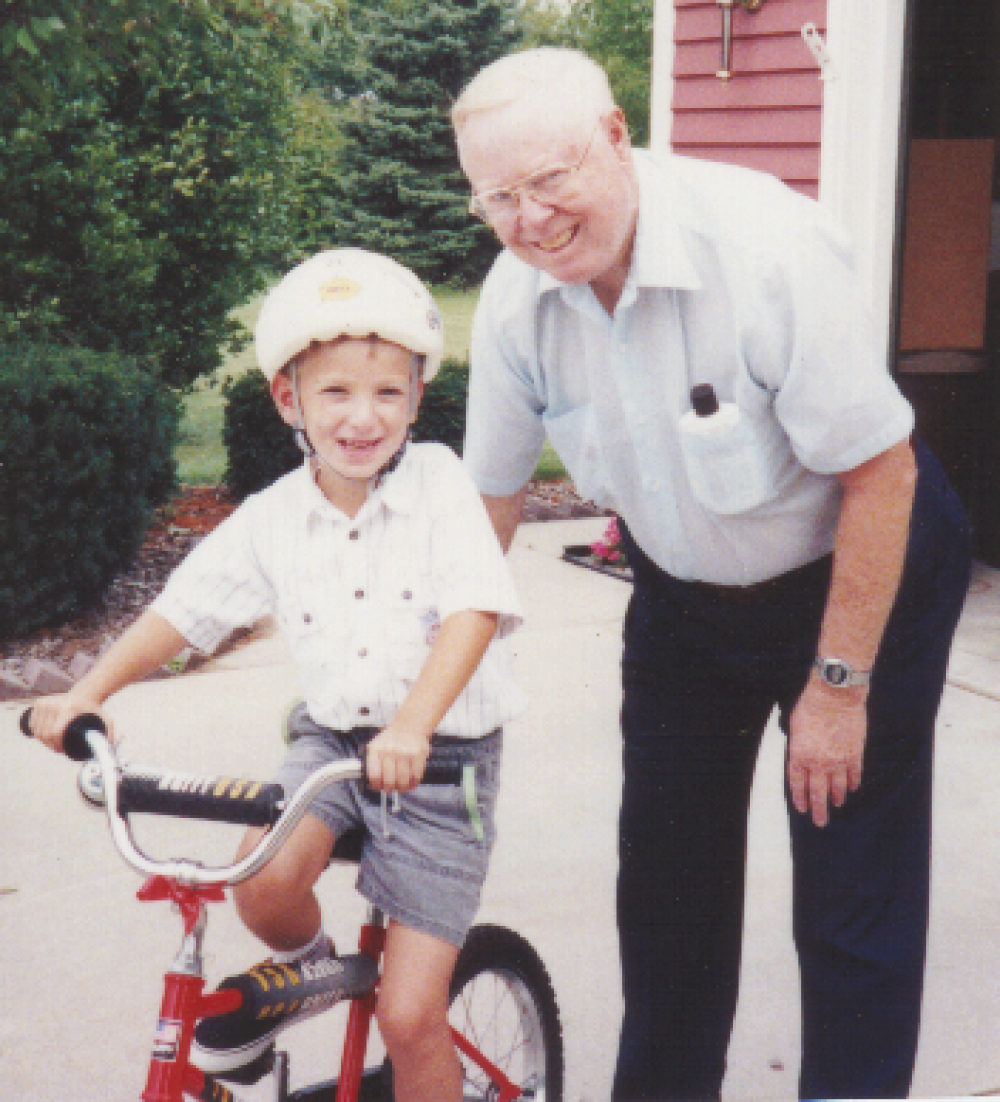 Grandfather teaching grandson to ride a bike