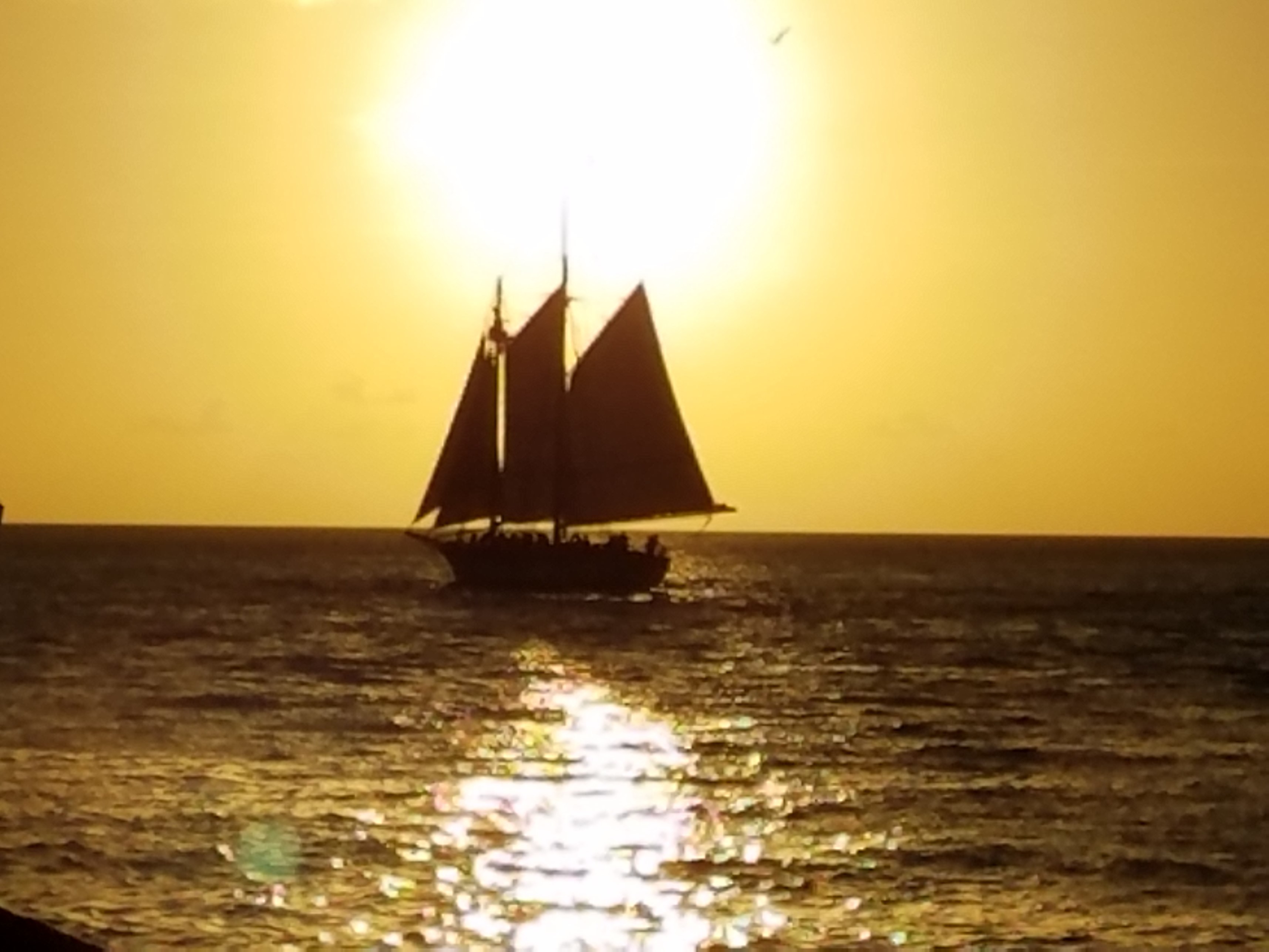Ship Sailing into Setting Sun