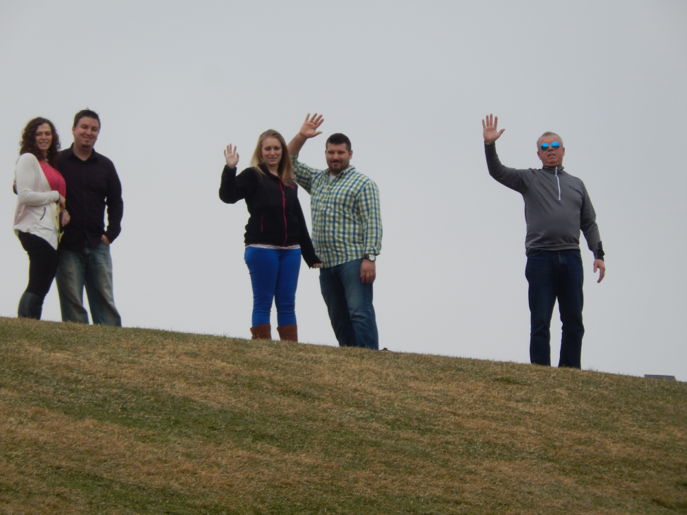 People on hill waiving goodbye